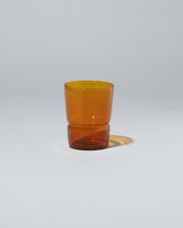 Ichendorf Milano Amber TAP Glass on light color background.