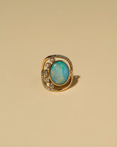 Australian Opal, Diamond & Sapphire Ring on light color background.