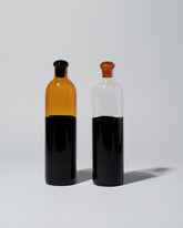 Group of Ichendorf Milano Black/Clear Light Colore Bottles on light color background.