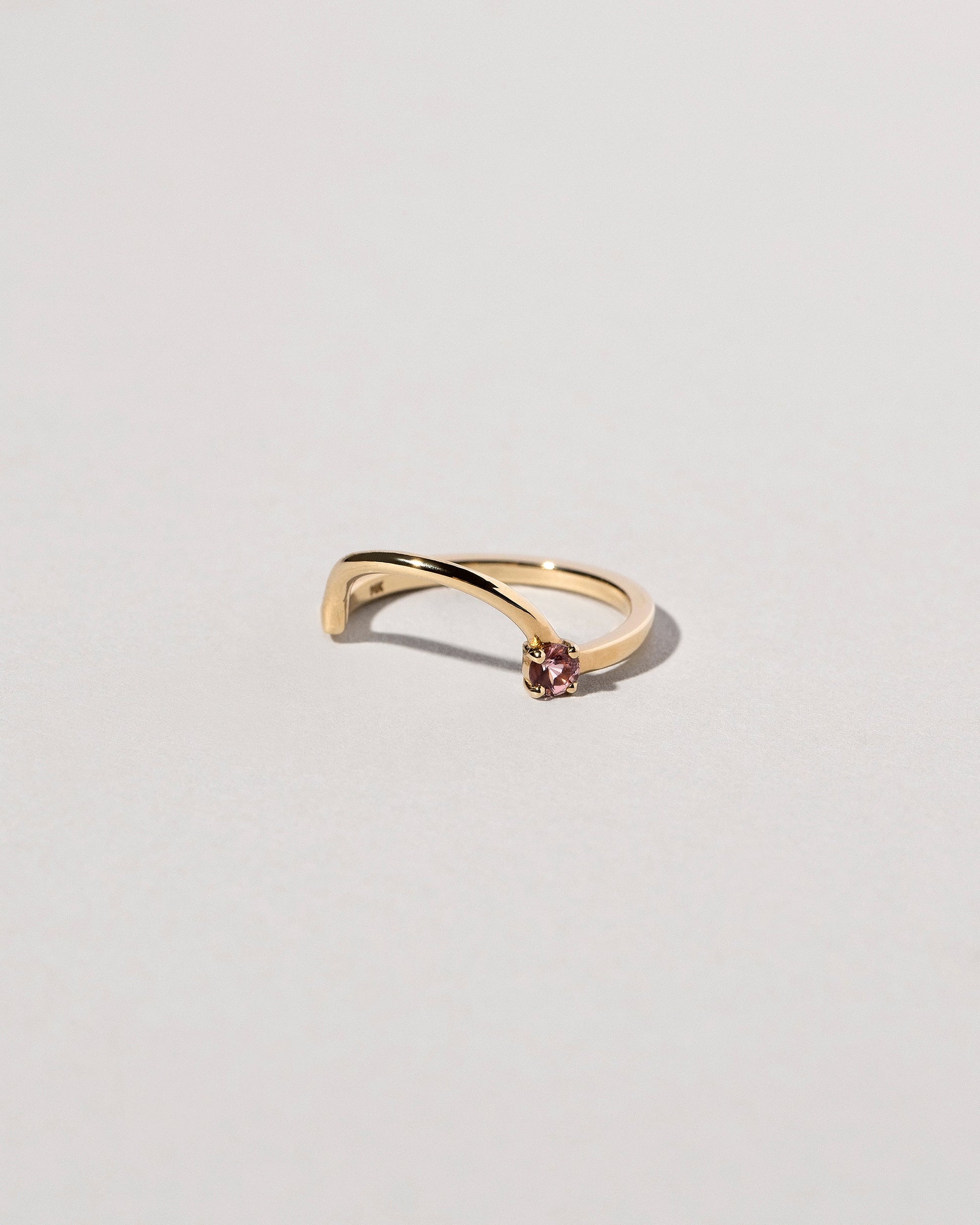 View from the side of the Yellow Gold Spinel Half Hoop Band on light color background.