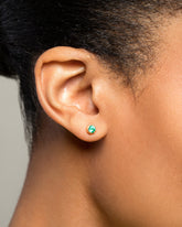 Emerald Sun & Moon Stud Earrings on model.