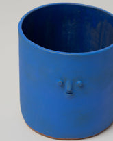 Detail view of Rami Kim Mini Face Pot on light color background.