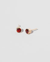  Garnet Studs on light color background.