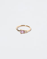 Pink Sapphire Teardrop Ring on light color background.