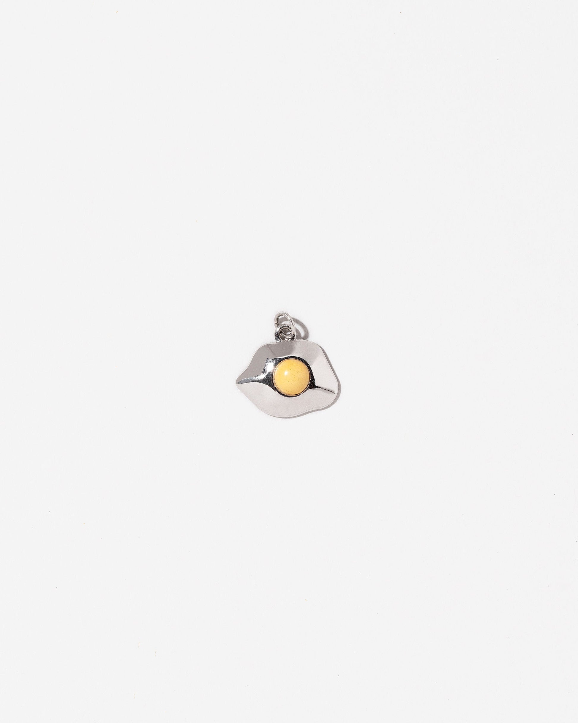 Sunny Side Up Egg Charm Two on light colored background.