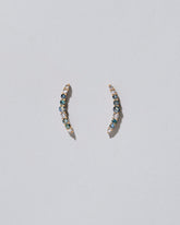 Crescent Ear Climber Stud Earrings - Sapphier and White Diamond on light colored background.