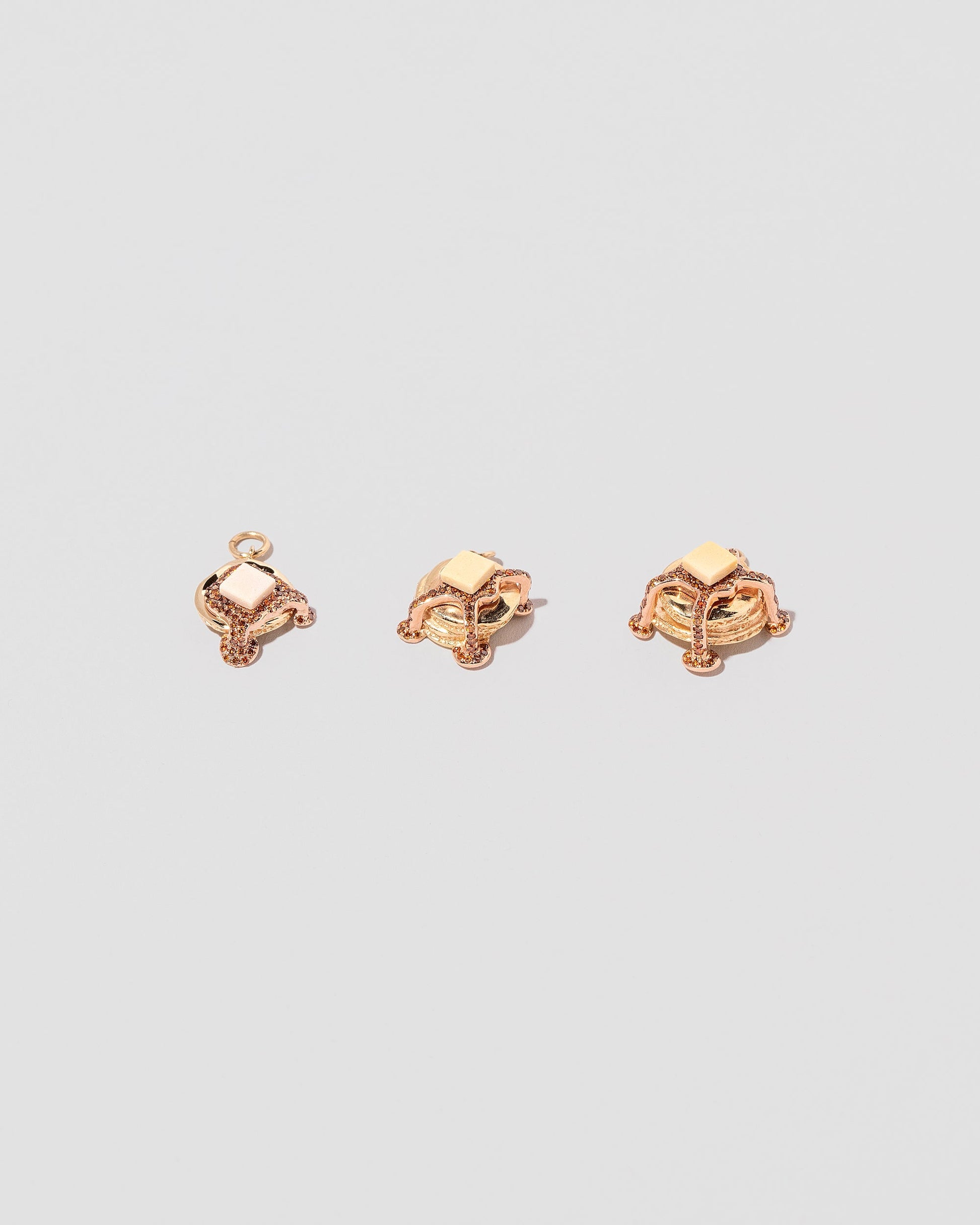 Group of Pancake Charms on light color background.