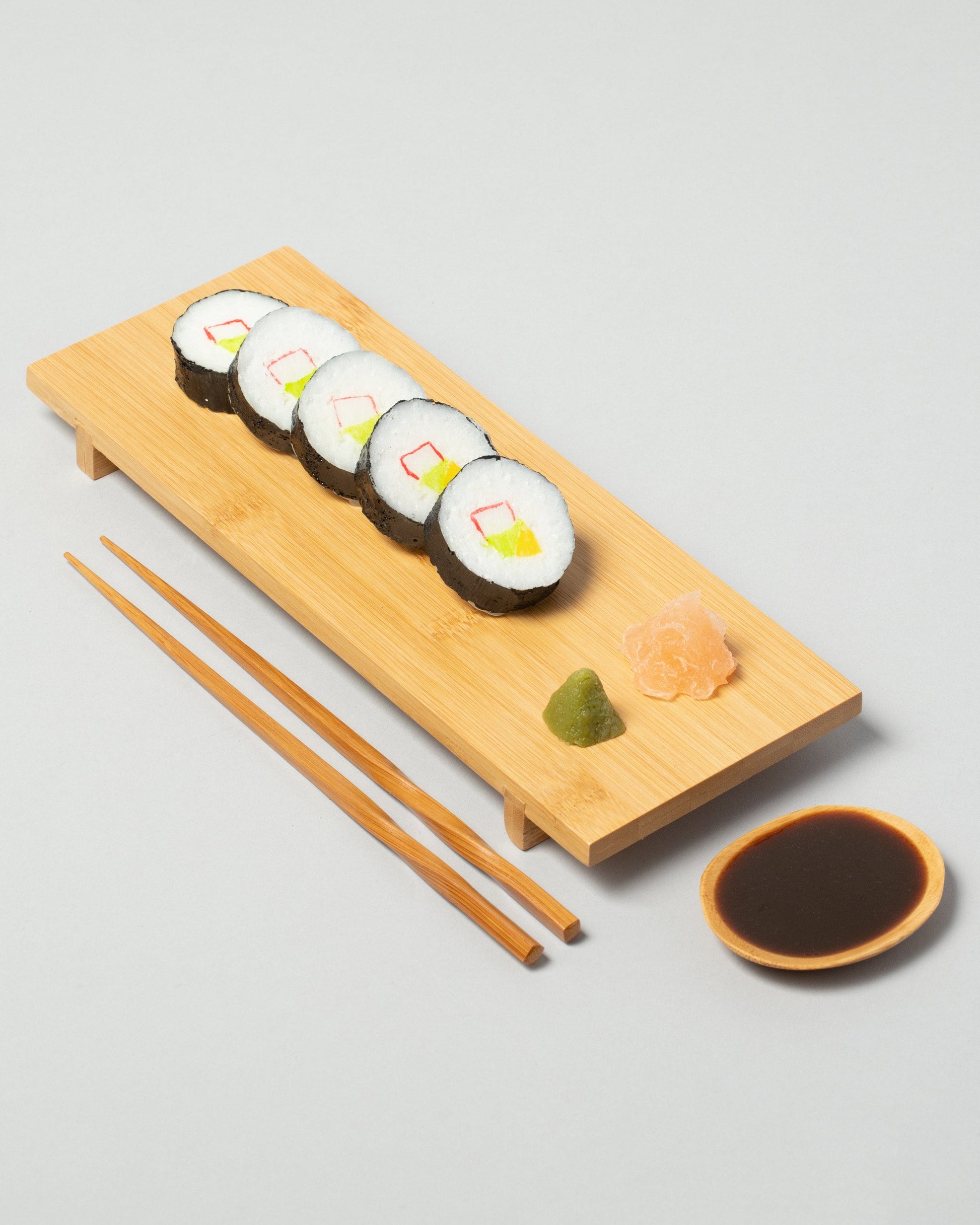 Spills California Roll Board Sushi Board on light color background.