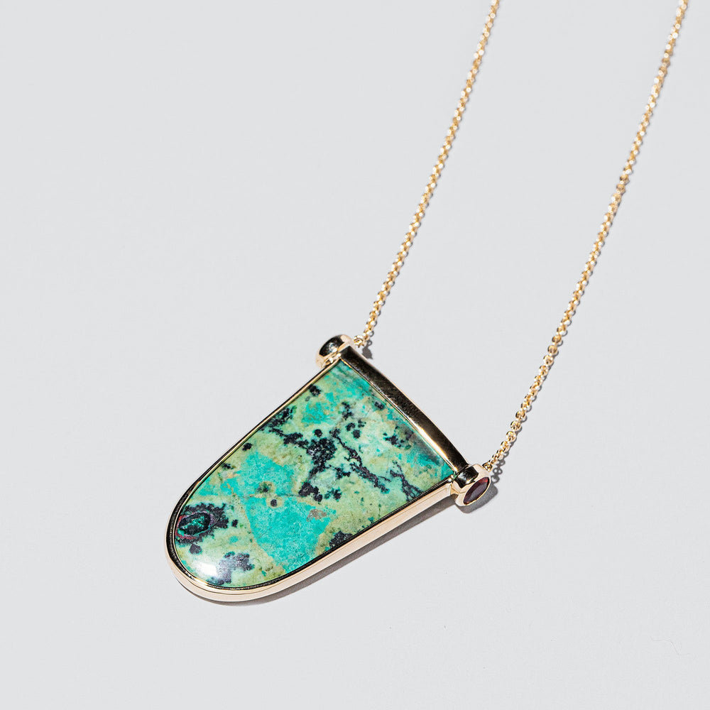 product_details::Chrysocolla Tongue Necklace on light color background.