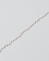 Closeup details of the Small Zipper Pearl Necklace on light color background.