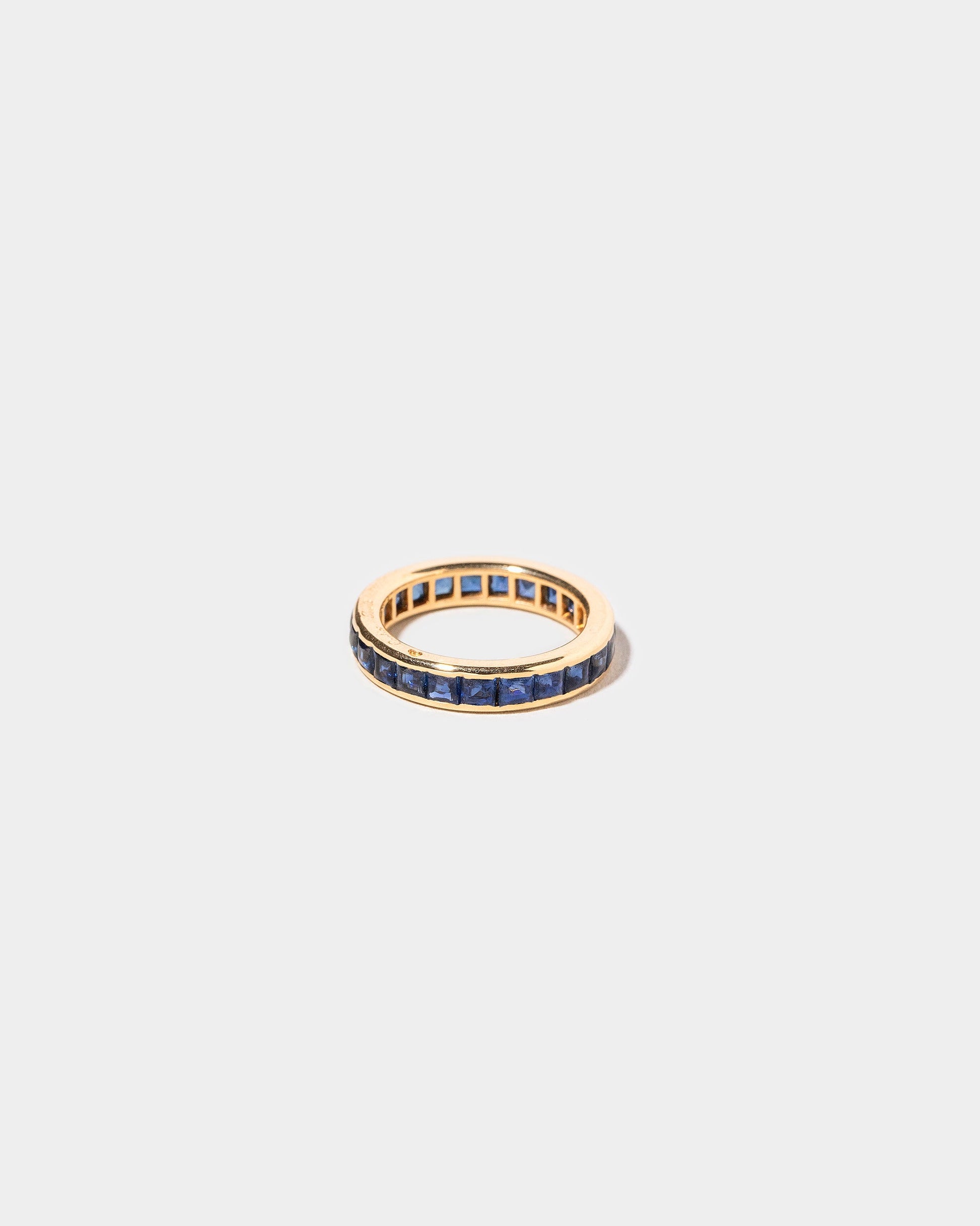  Cartier Sapphire Eternity Band on light color background.