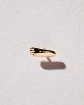 Foot Stud Earring Single on light color background.