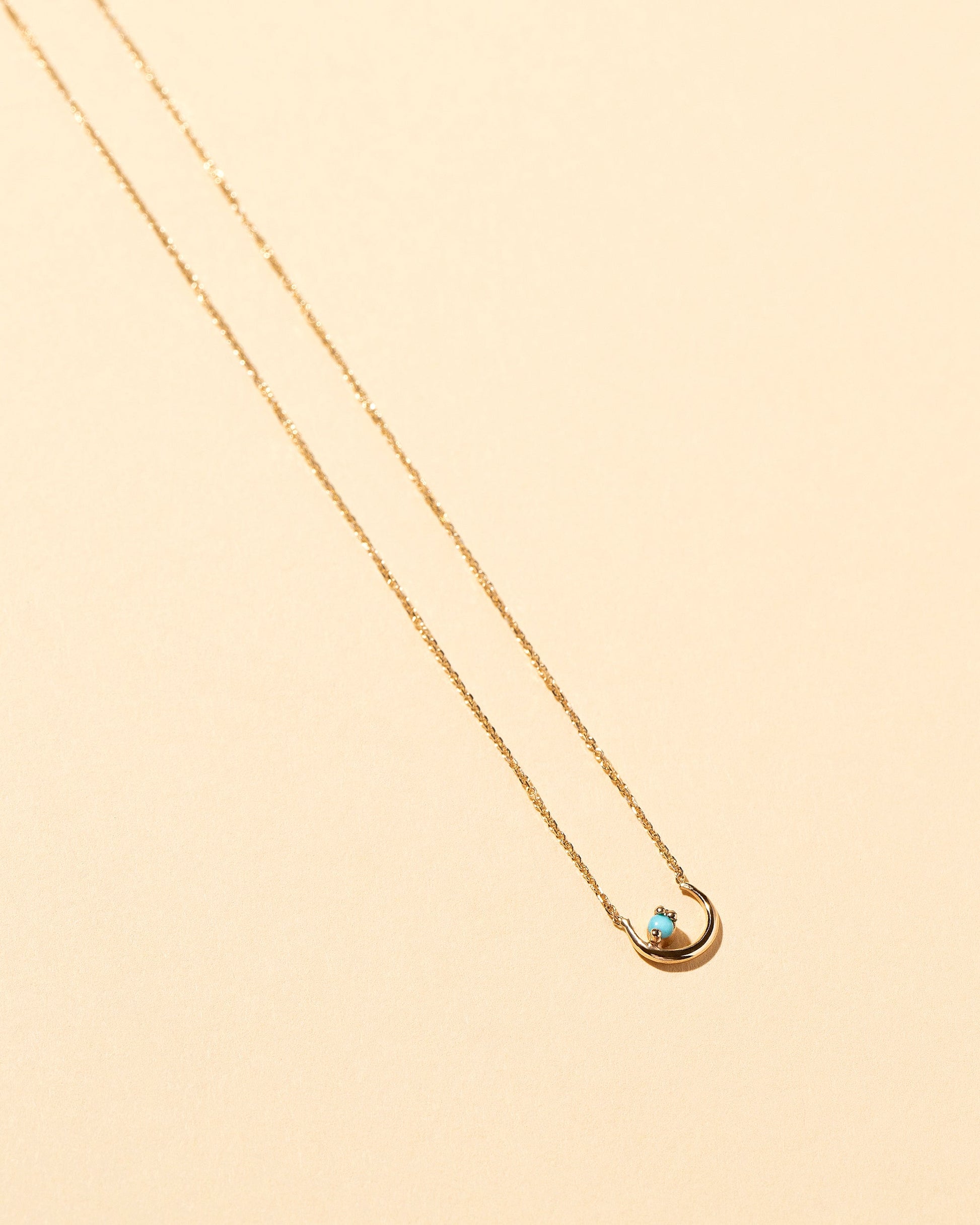  Moon Ray Necklace on light color background.