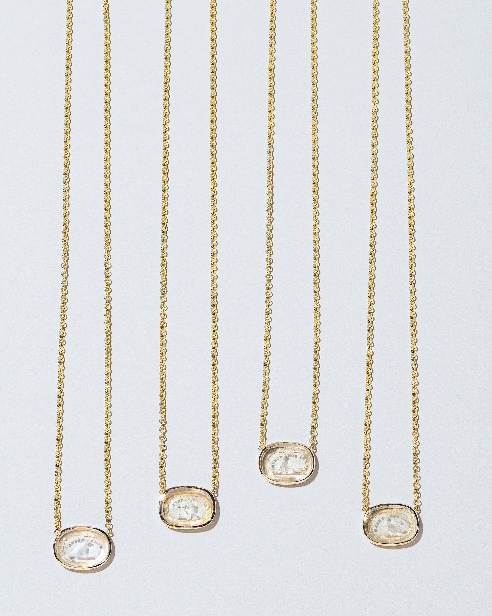 Group of Intaglio Necklaces on light colored background.