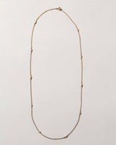  Natural Pink Seed Pearl Necklace on light color background.