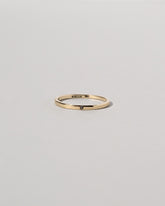Gold 1.5mm Square Wire Band with Single Stone Black Diamond 1.3mm on light color background.
