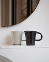 Styled image featuring Eric Bonnin Oatmeal and Gunmetal Kam Pitchers.