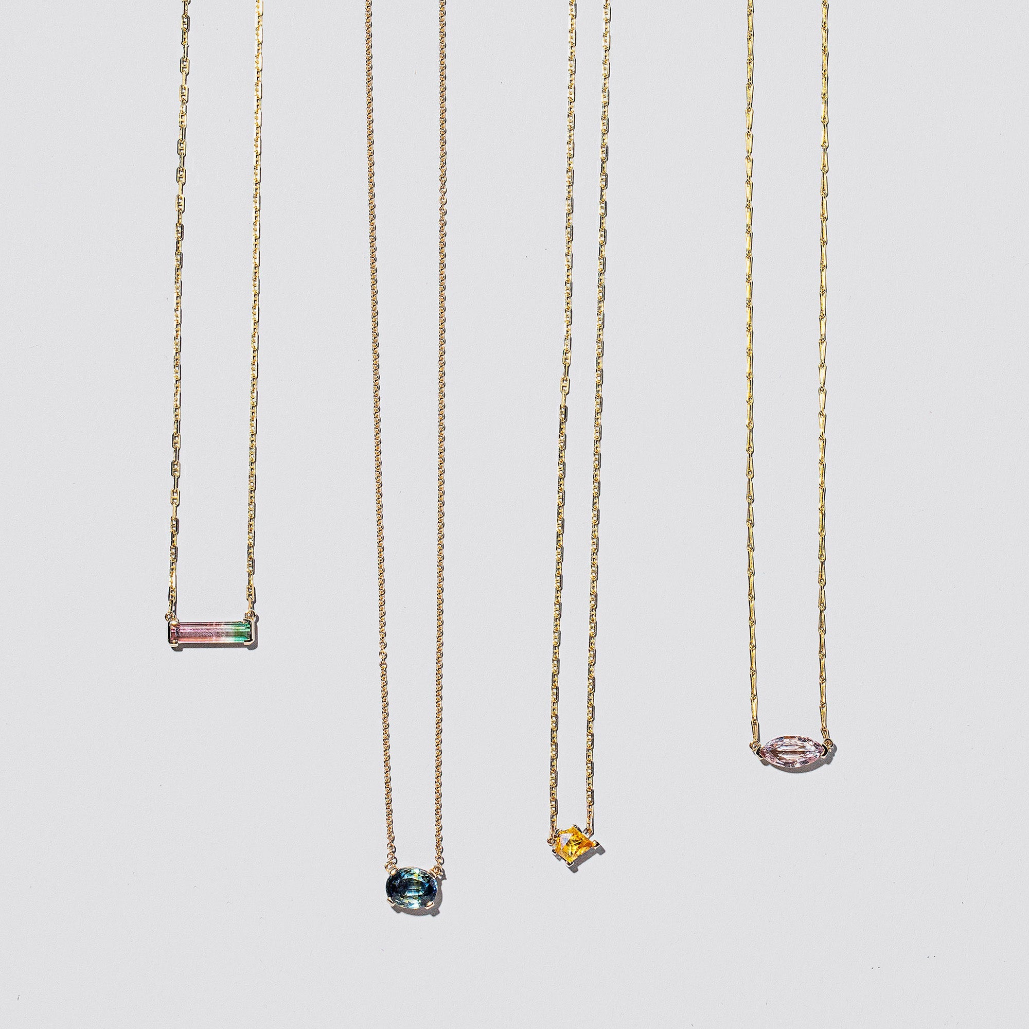 product_details::Group of Gemstone Necklaces on light color background.