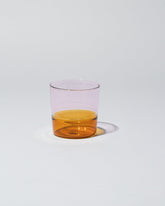Ichendorf Milano Amber/Pink Light Colore Water Glass on light color background.