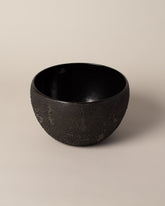 Detail view of Malka Dina Dew Black Serving Bowl on light color background.