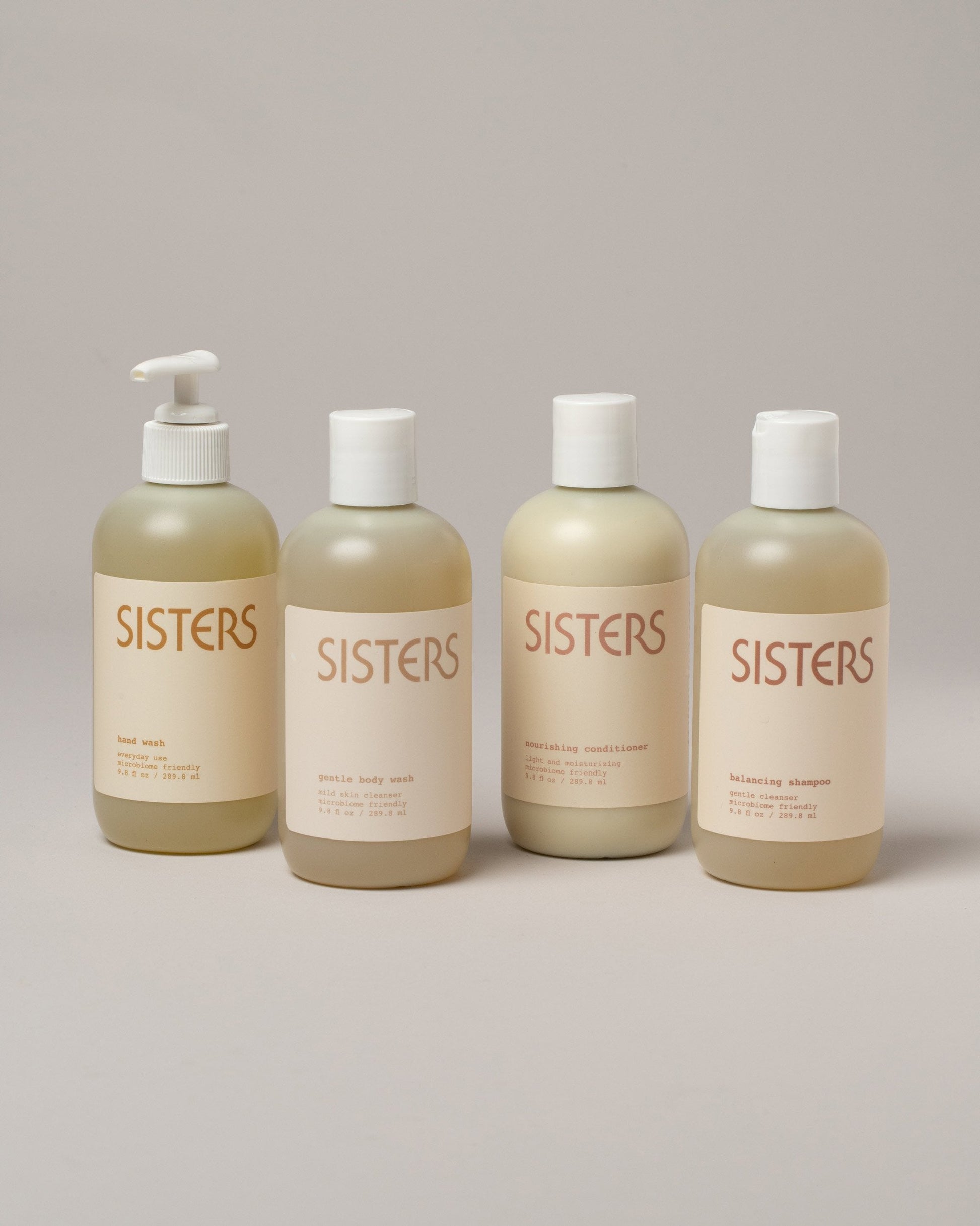 Sisters Body Hand Soap, Gentle Body Wash, Balancing Shampoo and Nourishing Conditioner on light color background.