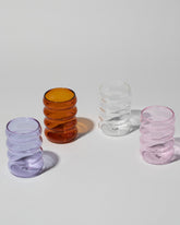 Group of Sophie Lou Jacobsen Small Pink, Small Purple, Small Clear and Small Amber Single Ripple Cups on light color background.