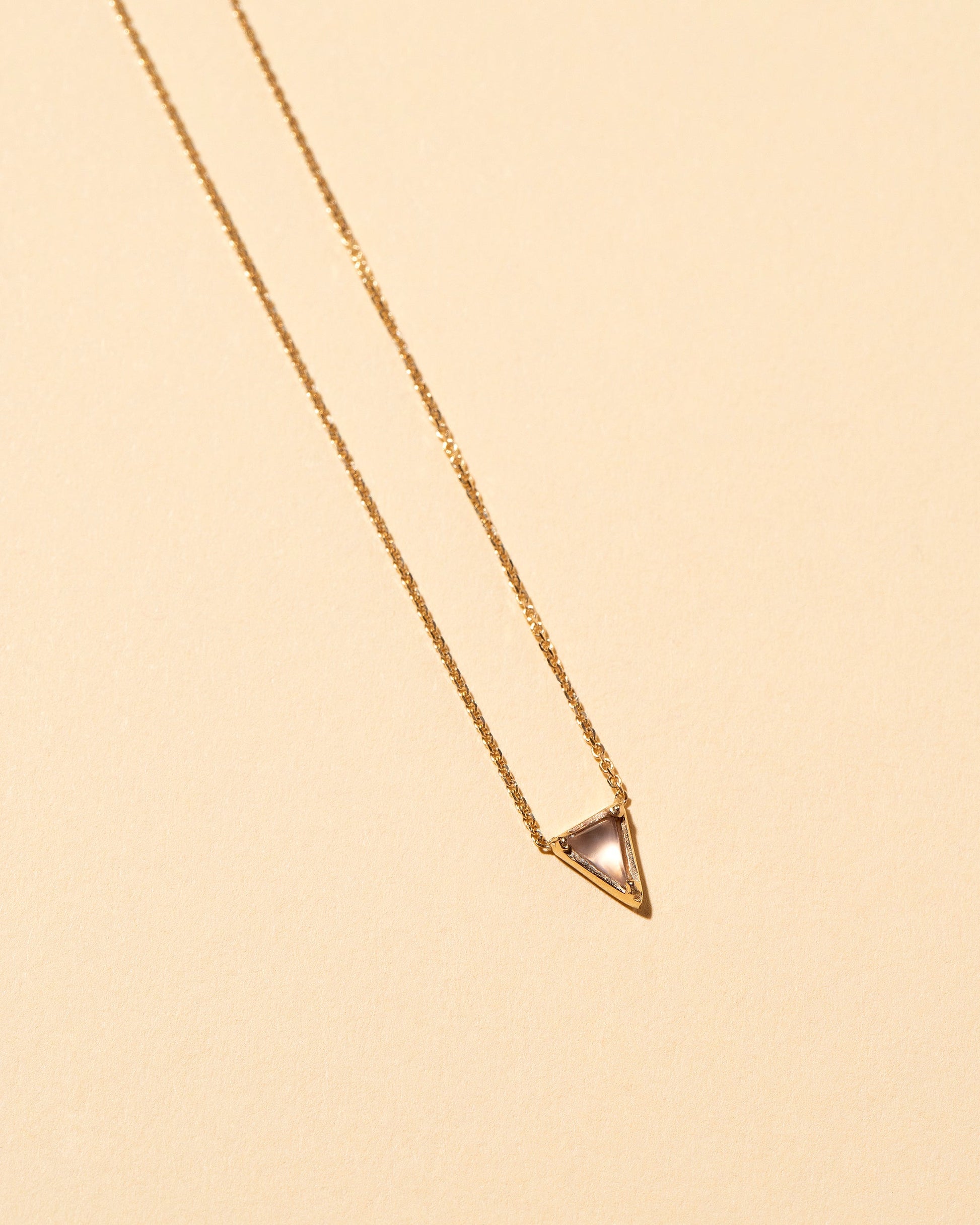  Triangle Necklace on light color background.