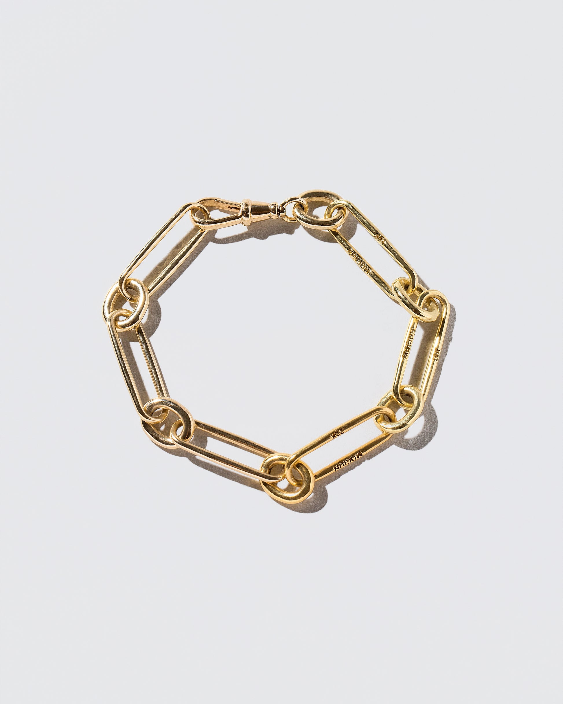Mixed Karat Link Bracelet on light color background.