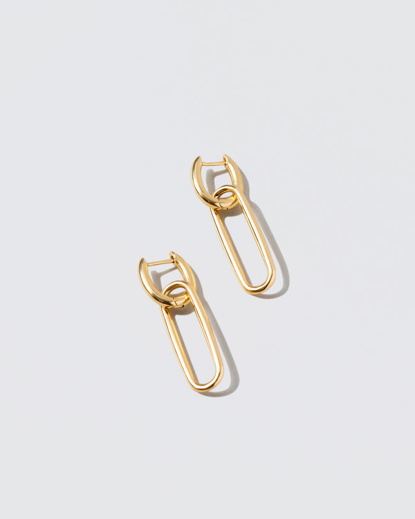 Link Huggie Hoop Earrings on light color background.