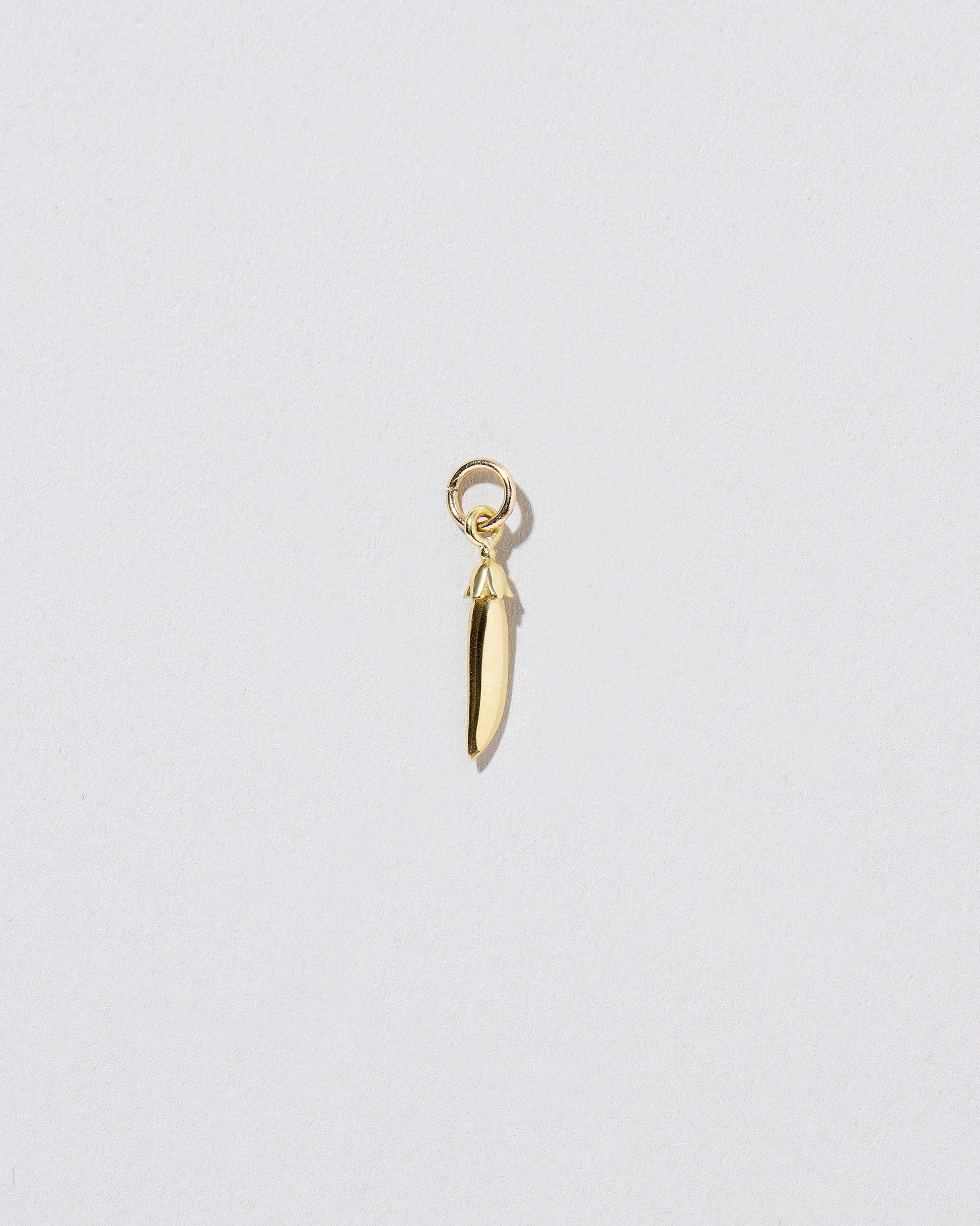 Snap Pea Charm on light colored background.