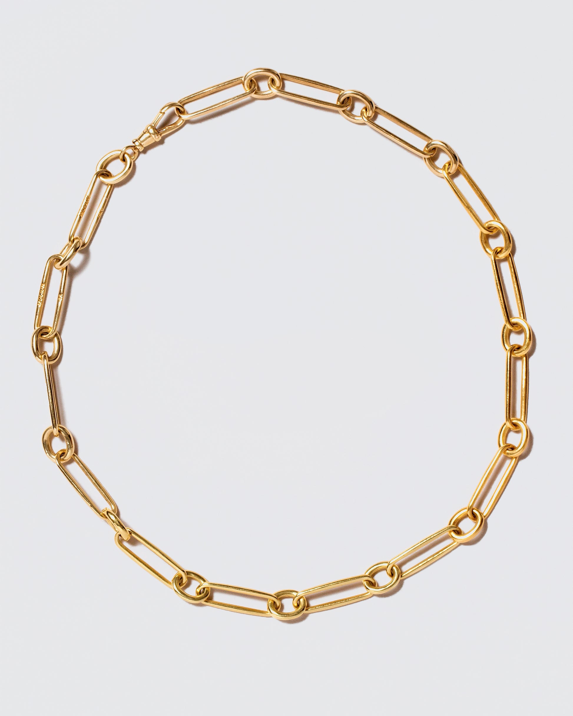 Link Necklace on light color background.
