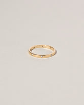 Gold 2mm Square Wire Band with Six Stone White Diamond 1.6mm added on light color background.