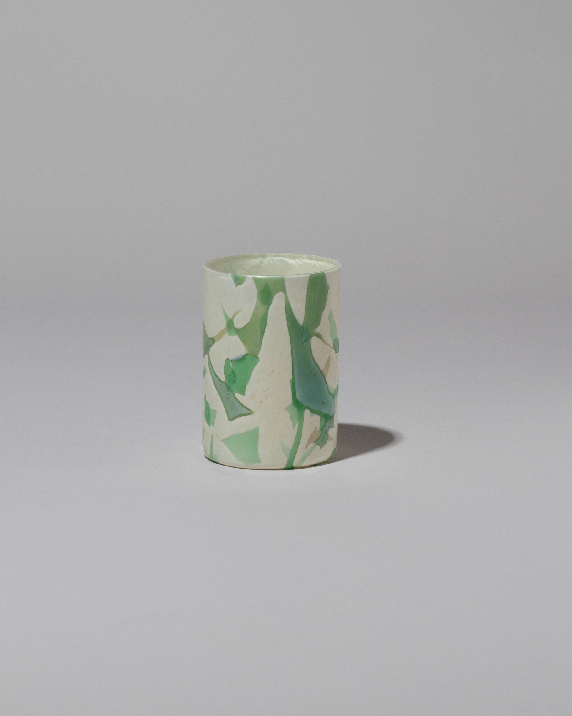 Stories of Italy Green Nougat Glass Tumbler on light color background.