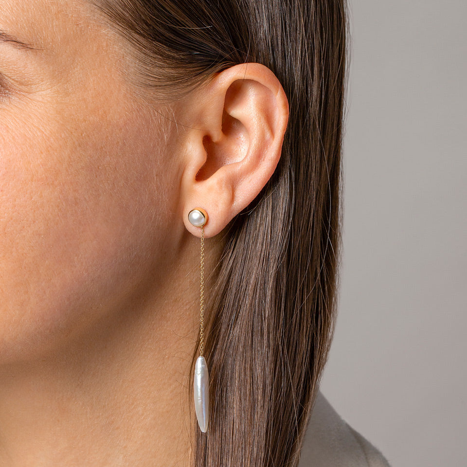 product_details::Navette Pearl Drop Earrings on model.
