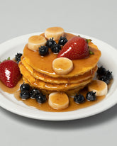 Spills Pancakes with Fruit Pancakes & Waffles on light color background.