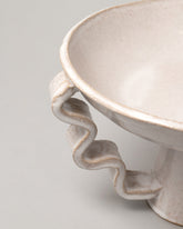 Detail view of Morgan Peck Pearl Stretch Bowl on light color background.