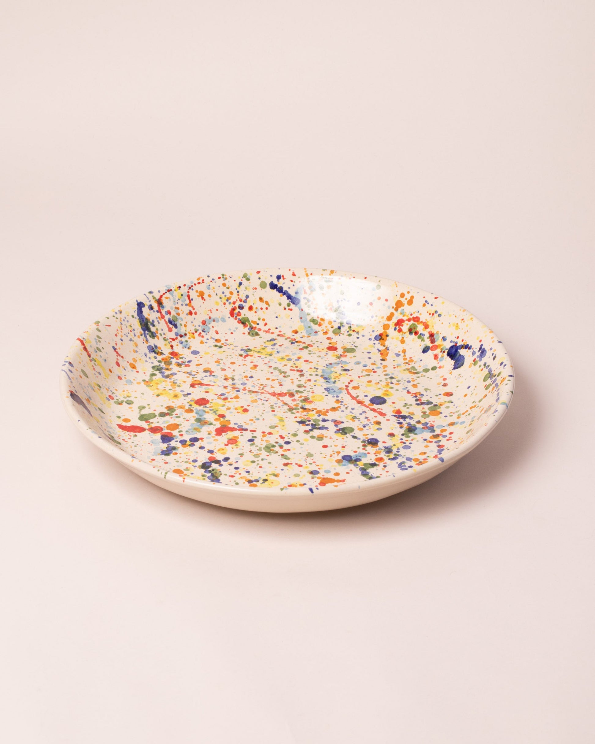 La Ceramica Vincenzo Del Monaco Colored Drops Circular Serving Dish on light color background.