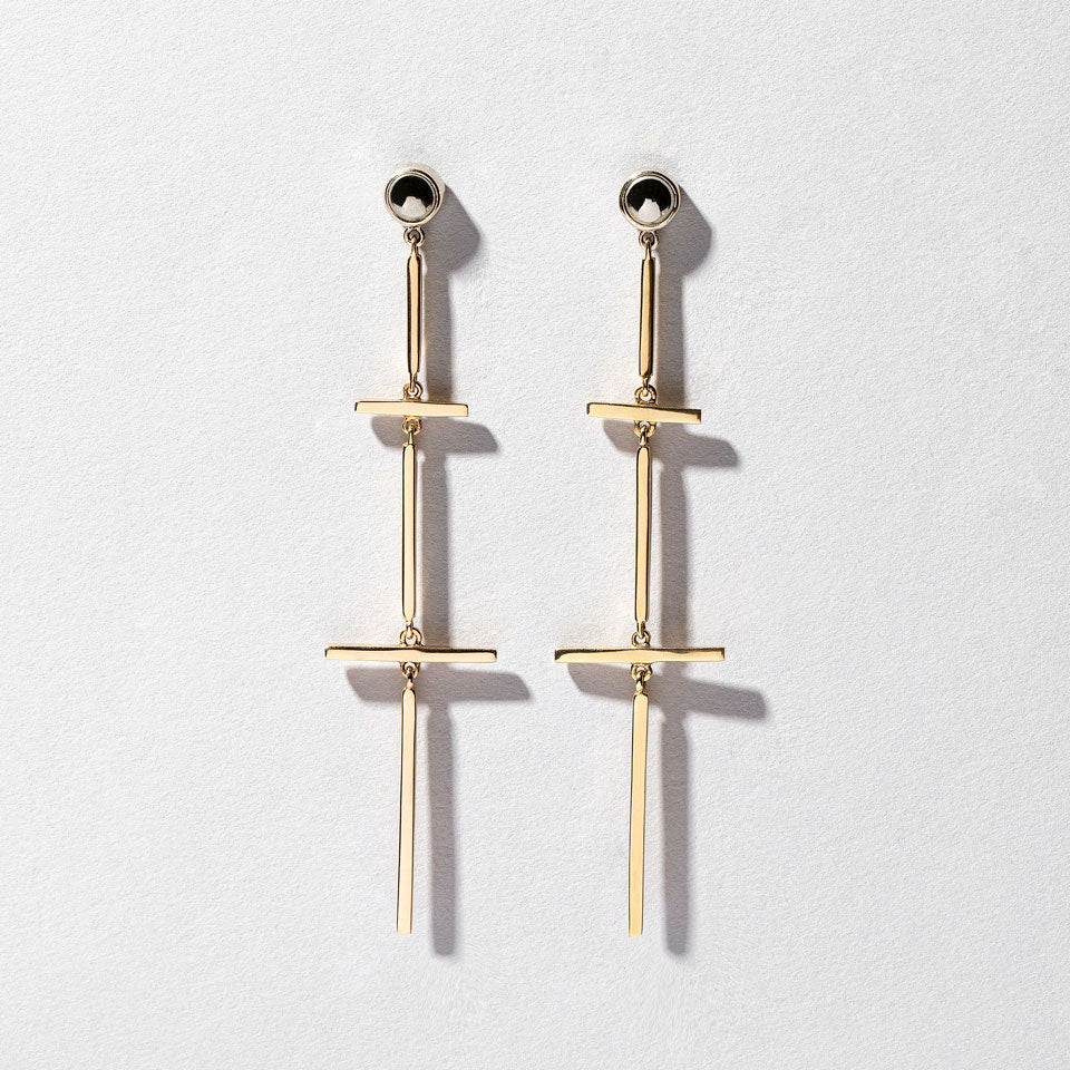 product_details:: Figure 6. Drop Earrings on light color background.