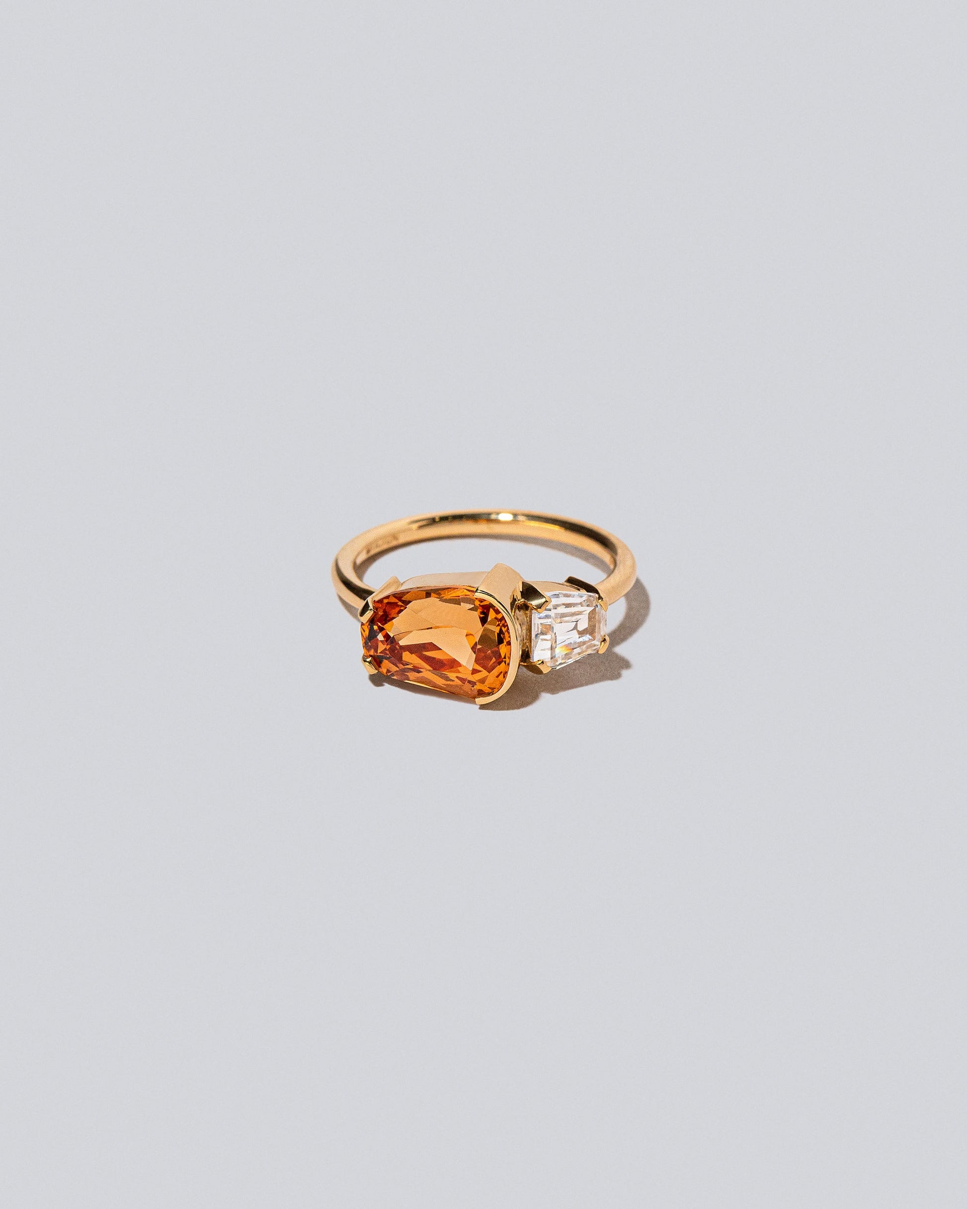 Product photo of the Golden Poppy Ring on a light color background 