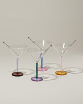 Group of Sophie Lou Jacobsen Lilac & Amber, Evergreen & Lilac, Royal Blue & Pink and Pink & Honey Piano Cocktail Glasses on light color background.