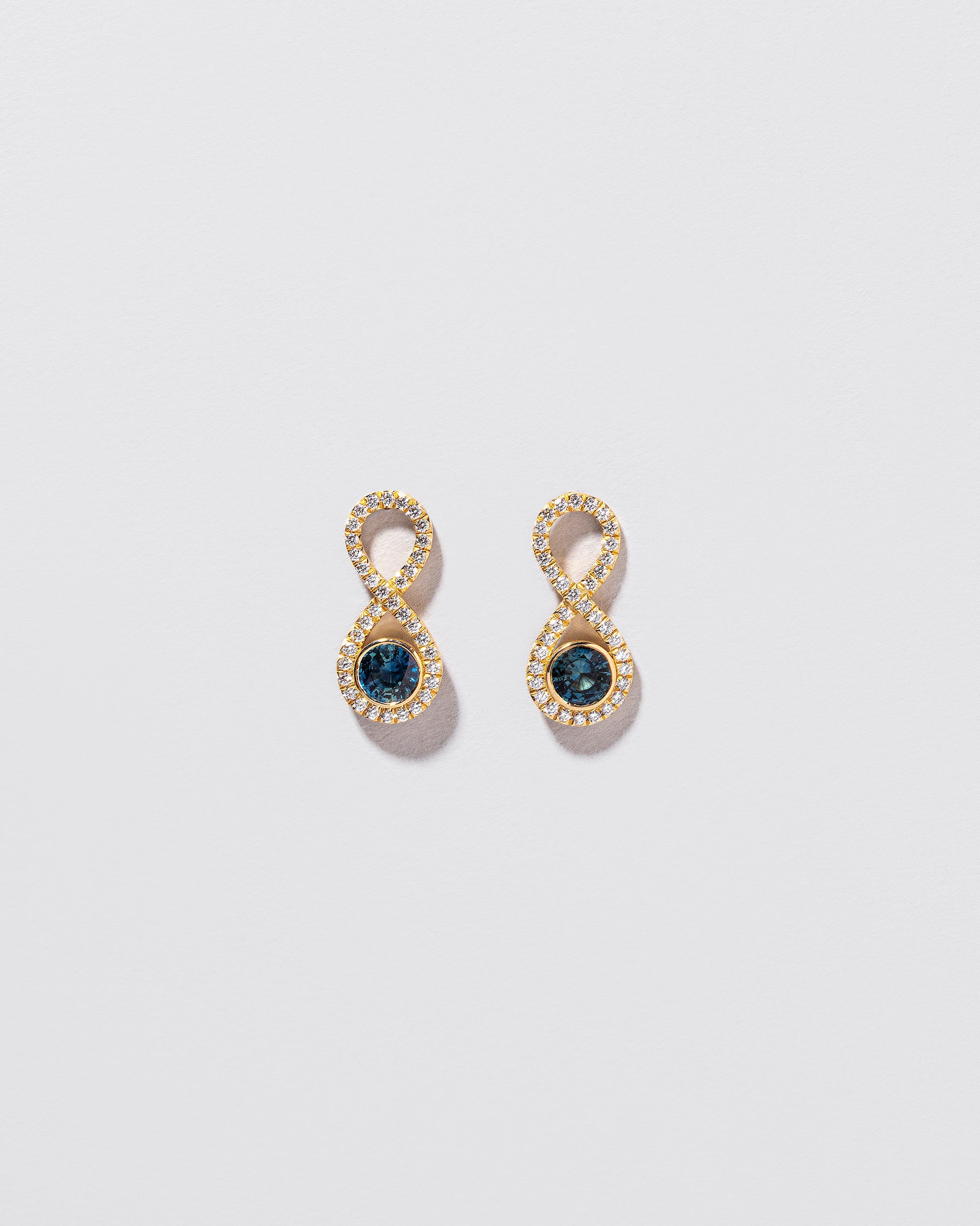  Ouroboros Earring on light color background.