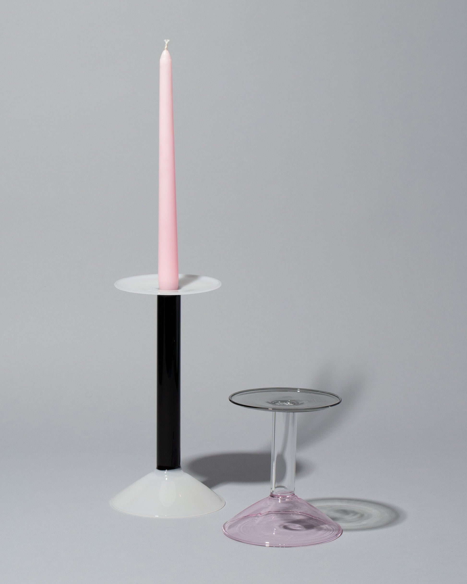 Group of Ichendorf Milano Medium White/Black and Small Pink/Clear/Grey Rainbow Candleholders on light color background.