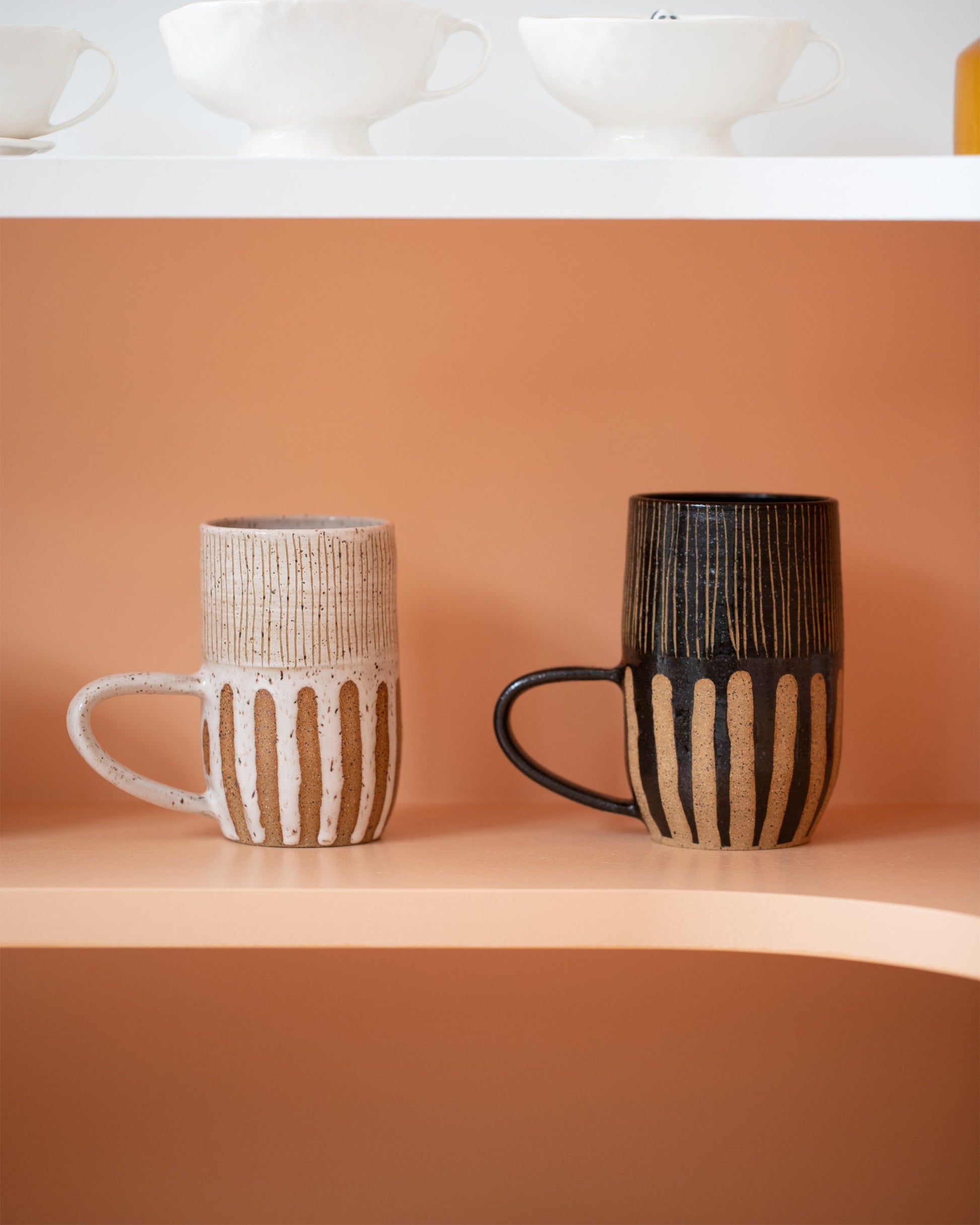 Styled group image of Little Bear Pots White Striped Mug and Little Bear Pots Black Striped Mug.