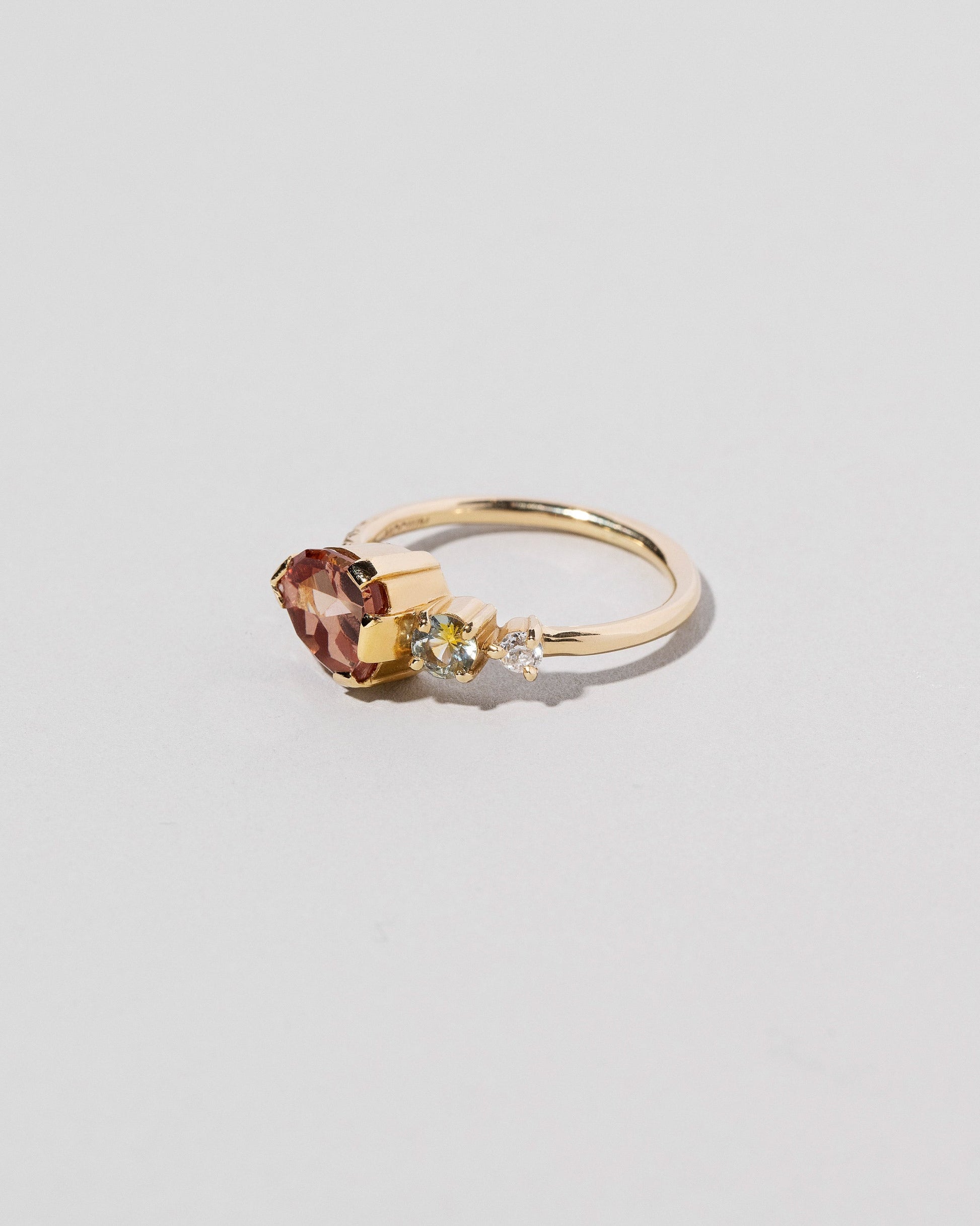  Garnet & Diamond Ring on light color background.