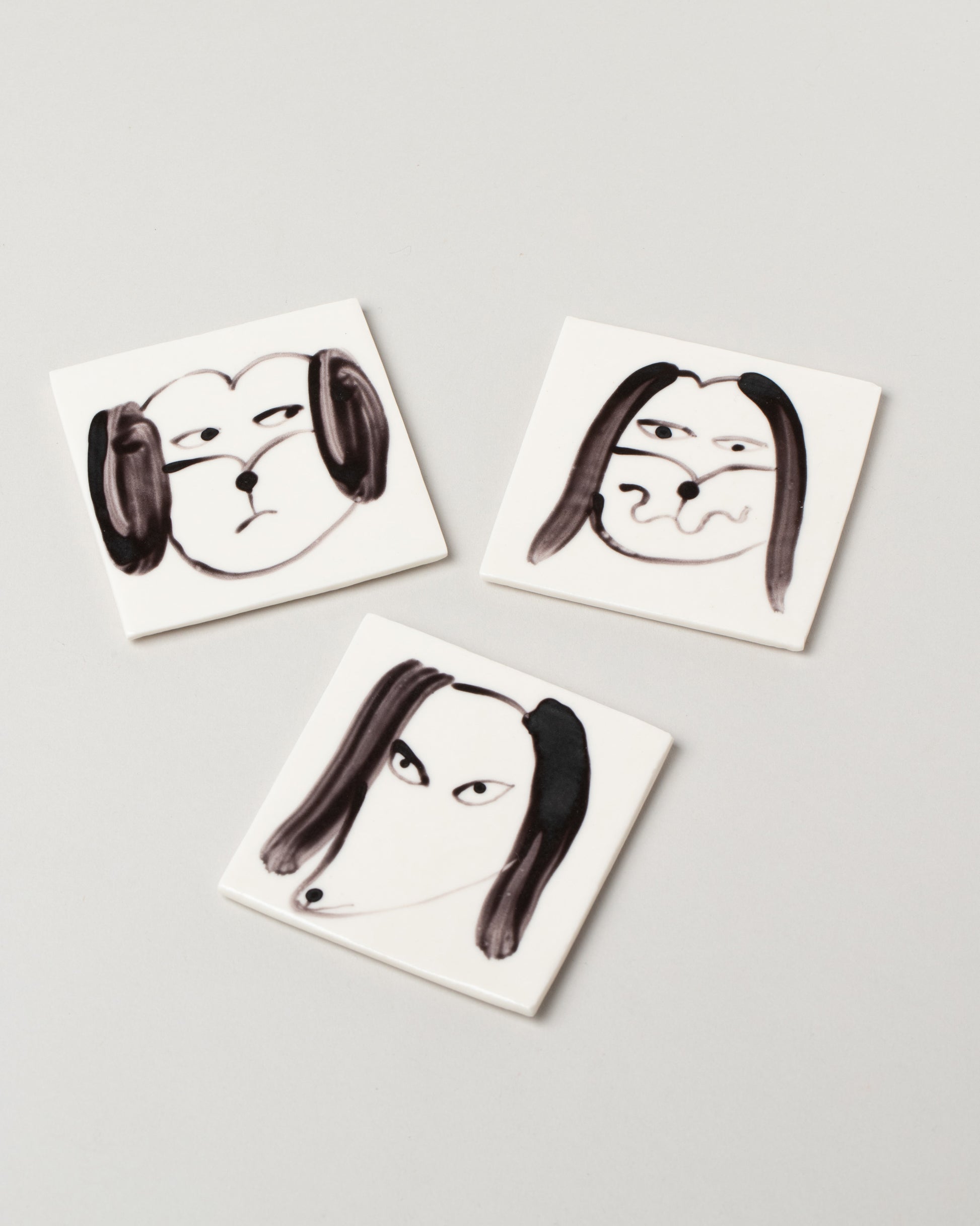 Closeup detail of the Eleonor Boström Dog Face Coasters on light color background.