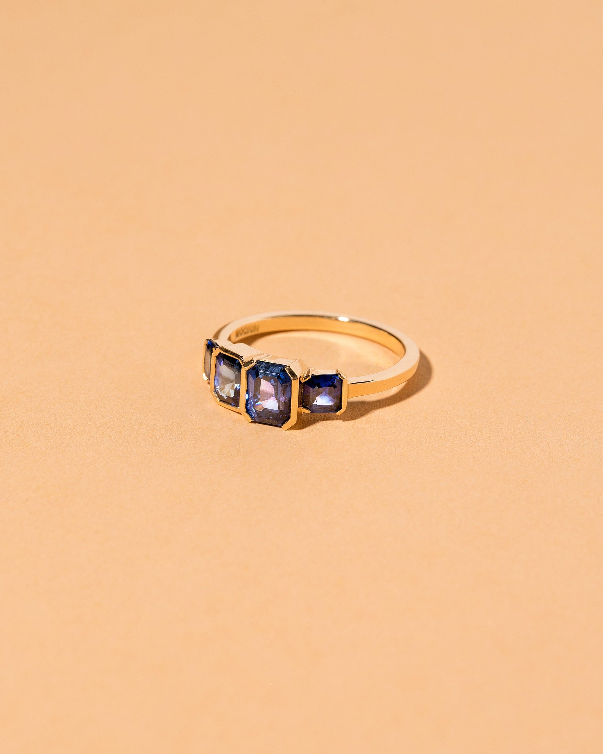  Geometric Sapphire Line Cluster Ring on light color background.