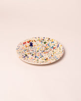Closeup details of the La Ceramica Vincenzo Del Monaco Colored Drops Medium Dish on light color background.