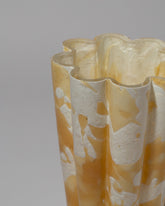 Closeup detail of the Stories of Italy Medium Amber Nougat Bucket Vase on light color background.