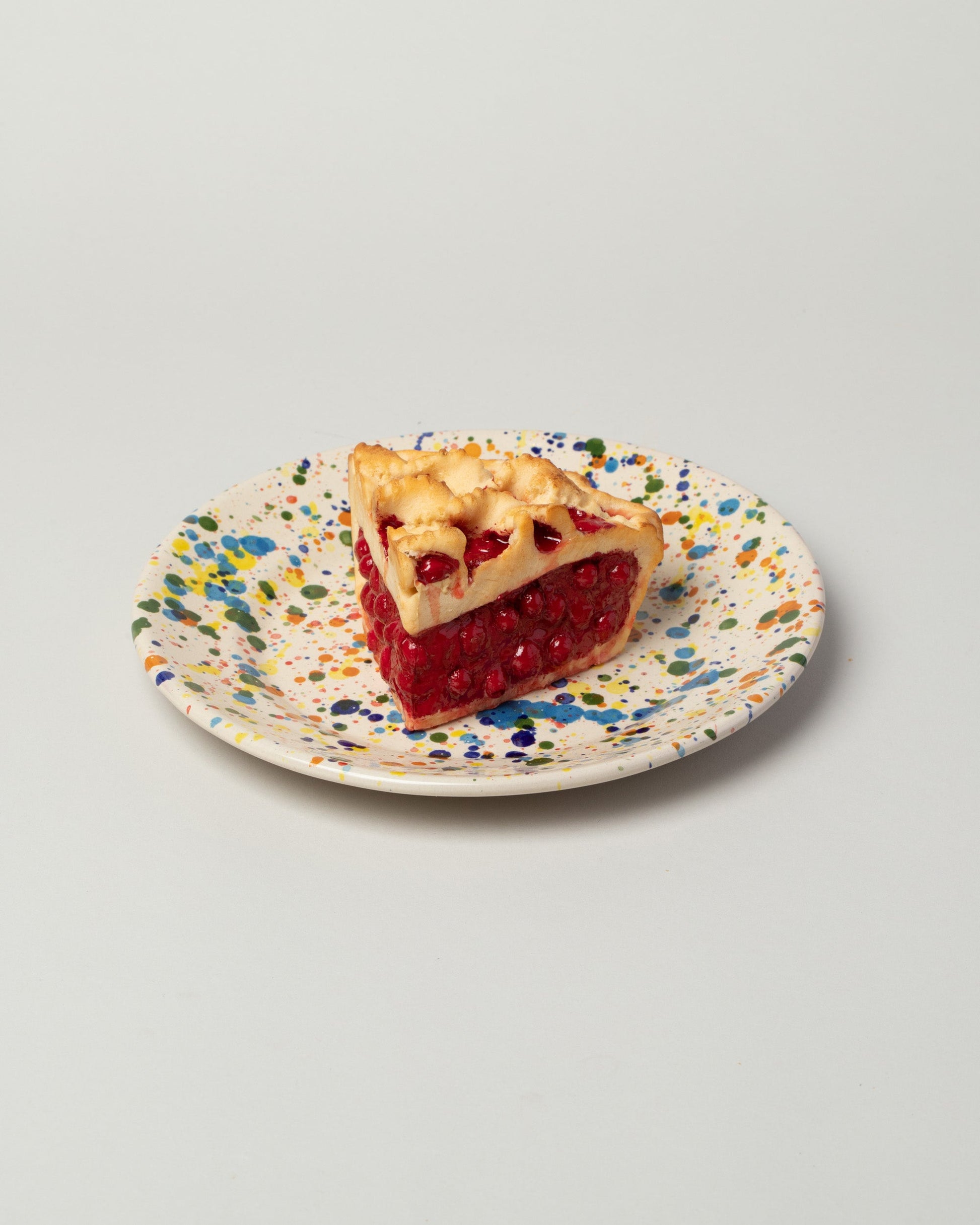 Detail view of the La Ceramica Vincenzo Del Monaco Colored Drops Medium Dish on light color background.