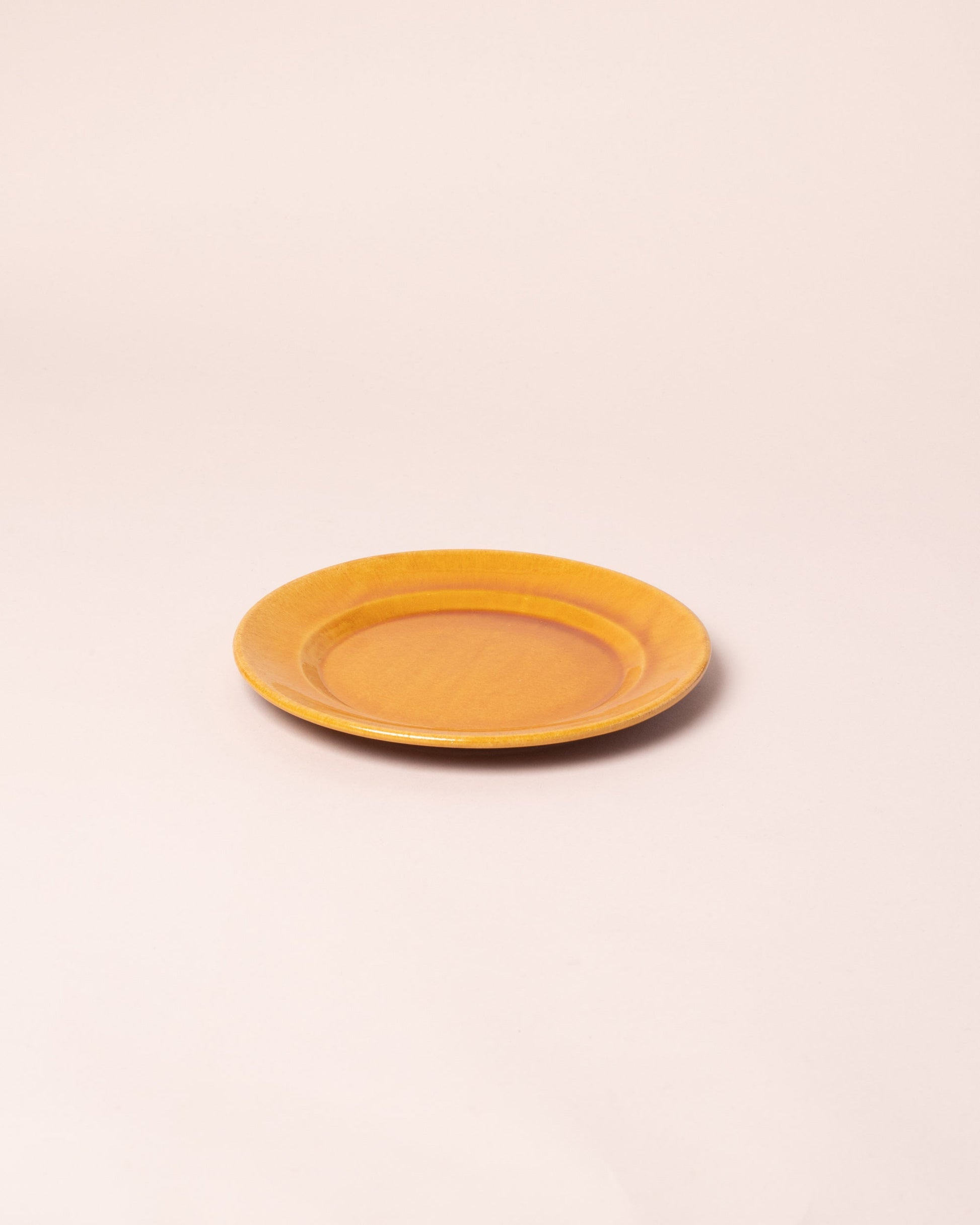 La Ceramica Vincenzo Del Monaco Caramel Yellow Small Dish on light color background.